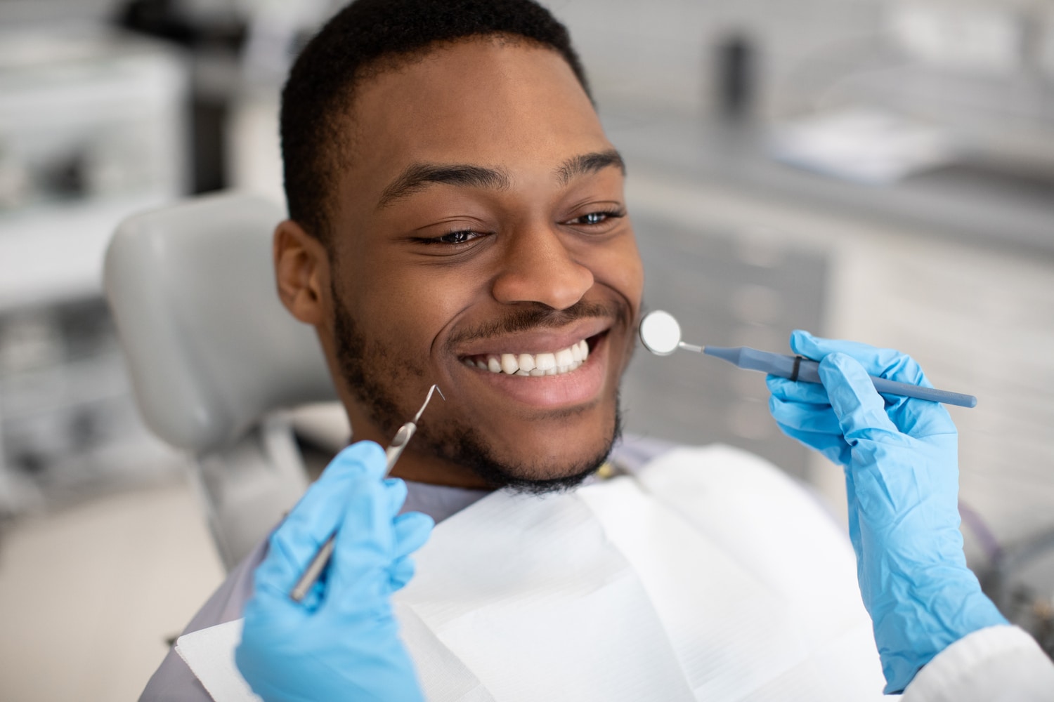 Dentistry Services. Young Male Patient Sitting In Chair In Dental Clinic